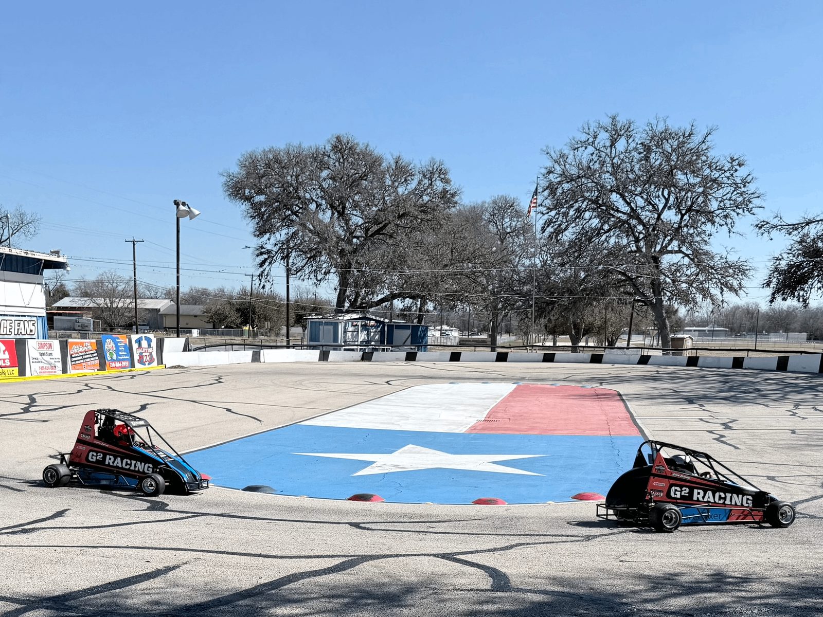Quarter midgets racing across a painted Texas flag infield