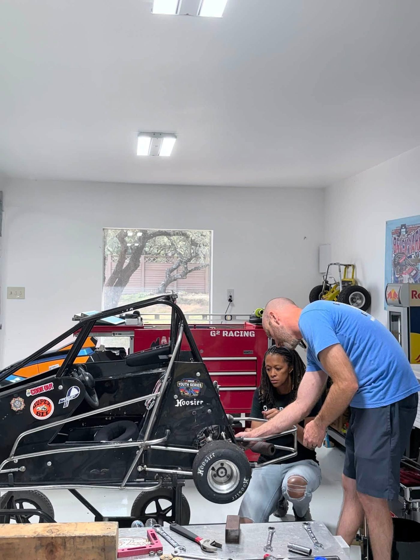 Working at the back of a quarter midget in the shop