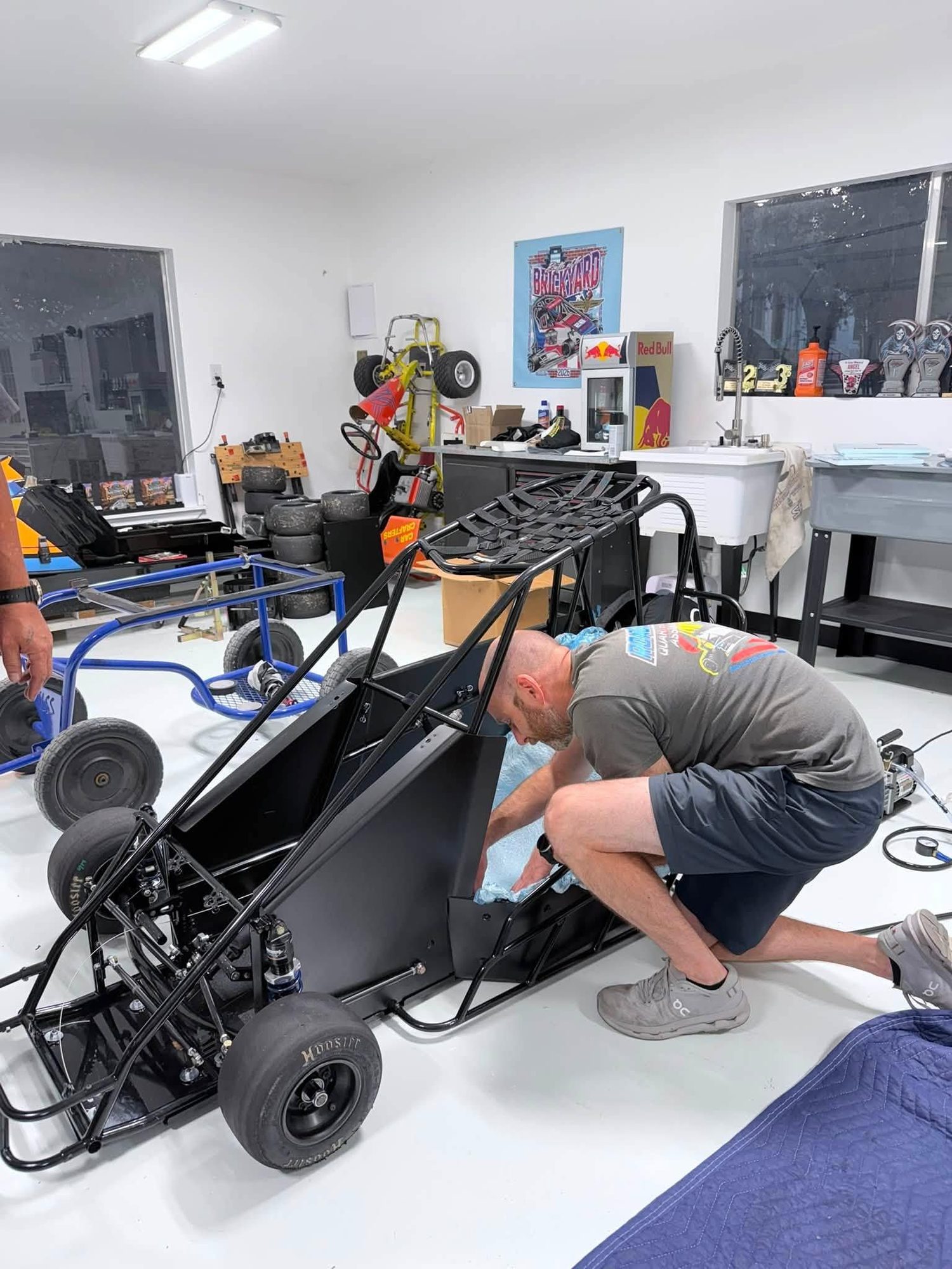 A quarter midget stripped down for setup work in the shop